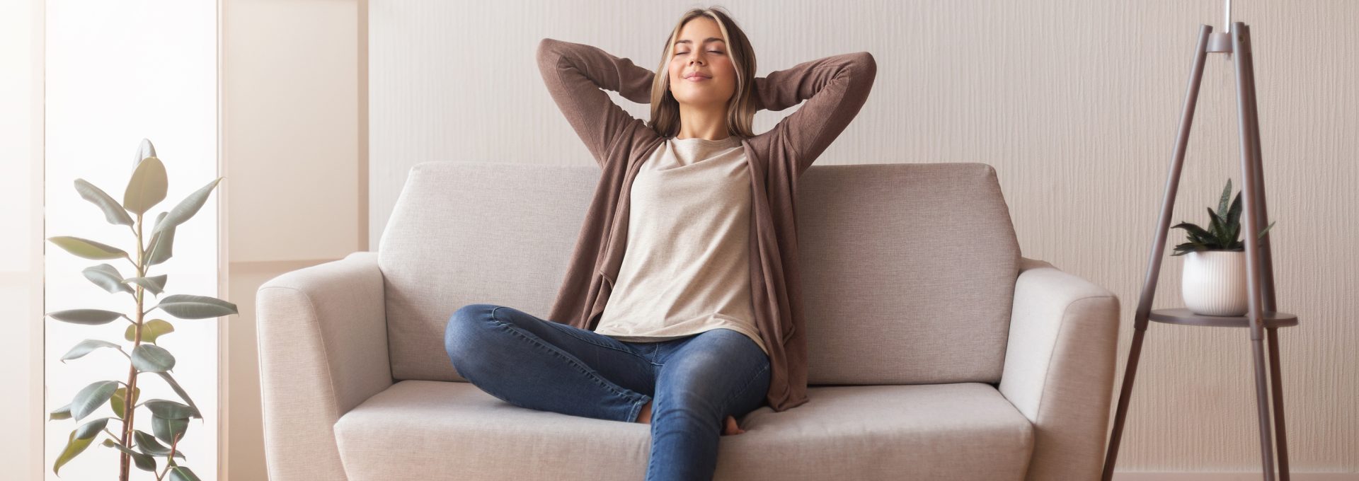 a woman is sitting on a couch and relaxing at The Woodview
