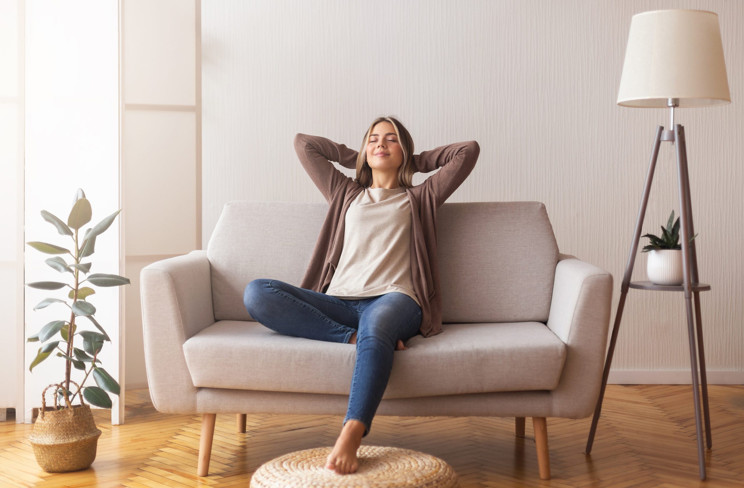 a woman is sitting on a couch and relaxing at The Woodview